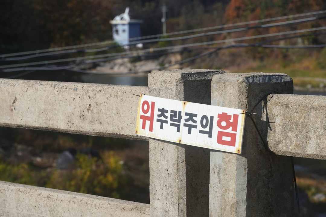 File photograph of a fence and warning sign in the Korean border area; not an image of the September 2026 mine blast or new weapons.