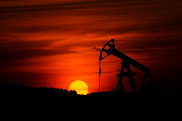 Oil pump jack at sunset, a contextual image for rising crude oil prices. Photo by Zbynek Burival on Unsplash.