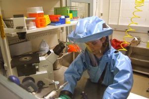 A researcher working in a Biosafety Level 4 hazmat suit