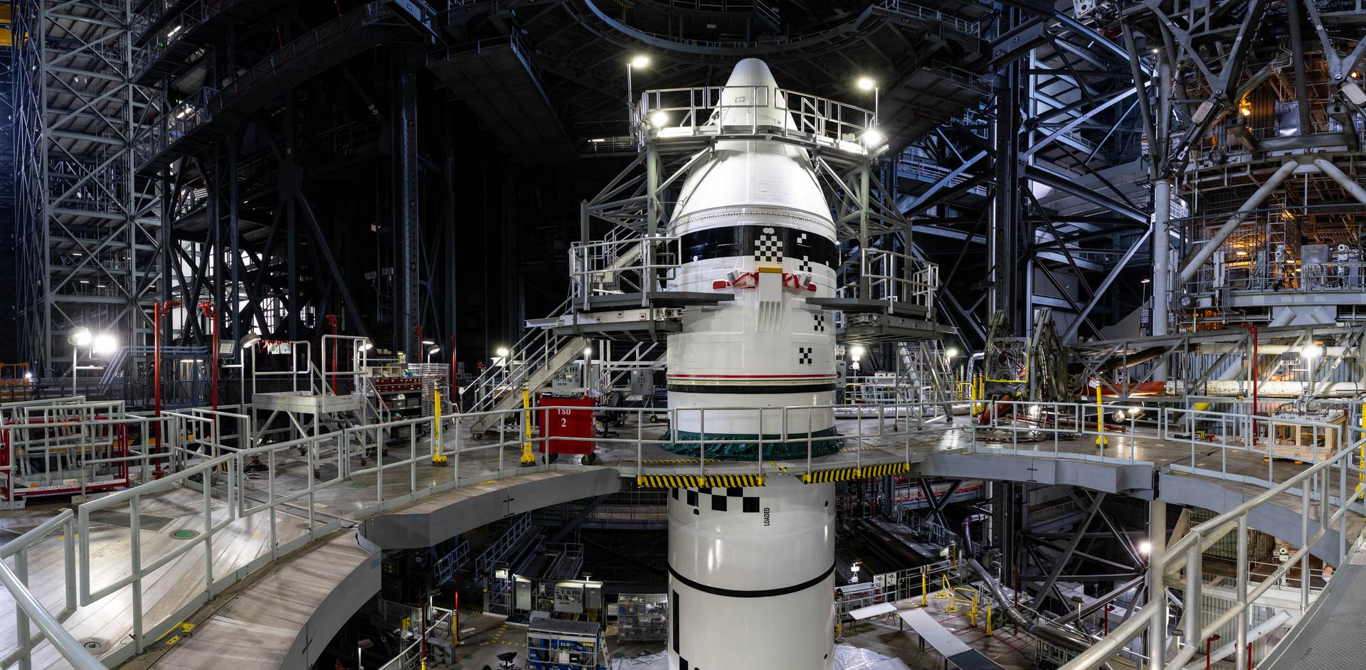 The completed left Artemis III booster with its nose cone installed in the Vehicle Assembly Building
