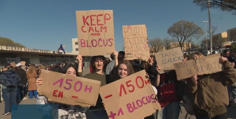 Students hold handmade signs during a high school blockade protest in France