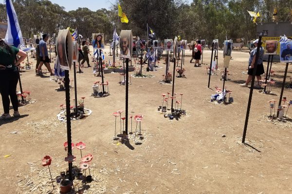 Memorial at the Nova music festival site in Re'im, Israel, with photos of victims