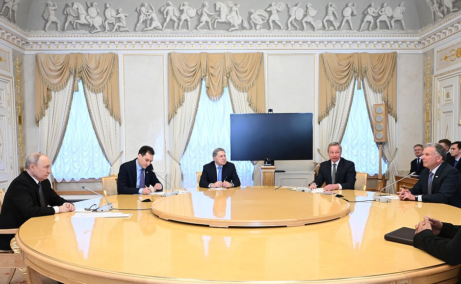 Vladimir Putin and Steve Witkoff seated at a round table with their delegations at the Constantine Palace.