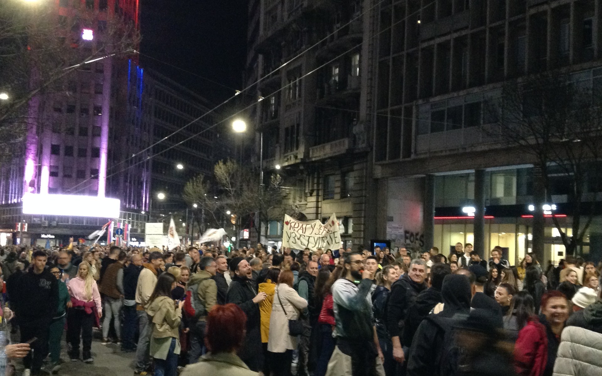 Crowd of protesters filling a Belgrade street at night, March 2025