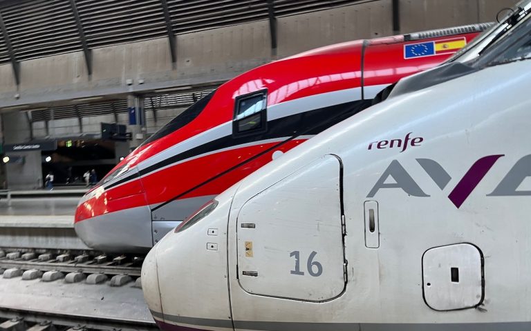 A Renfe AVE train alongside an Iryo Frecciarossa train at Sevilla Santa Justa station